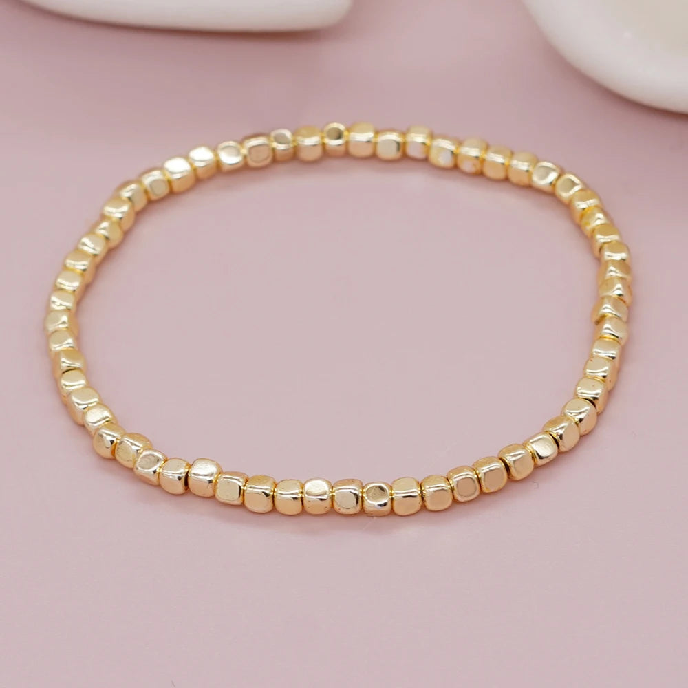 Bracelet billes dorées élastique