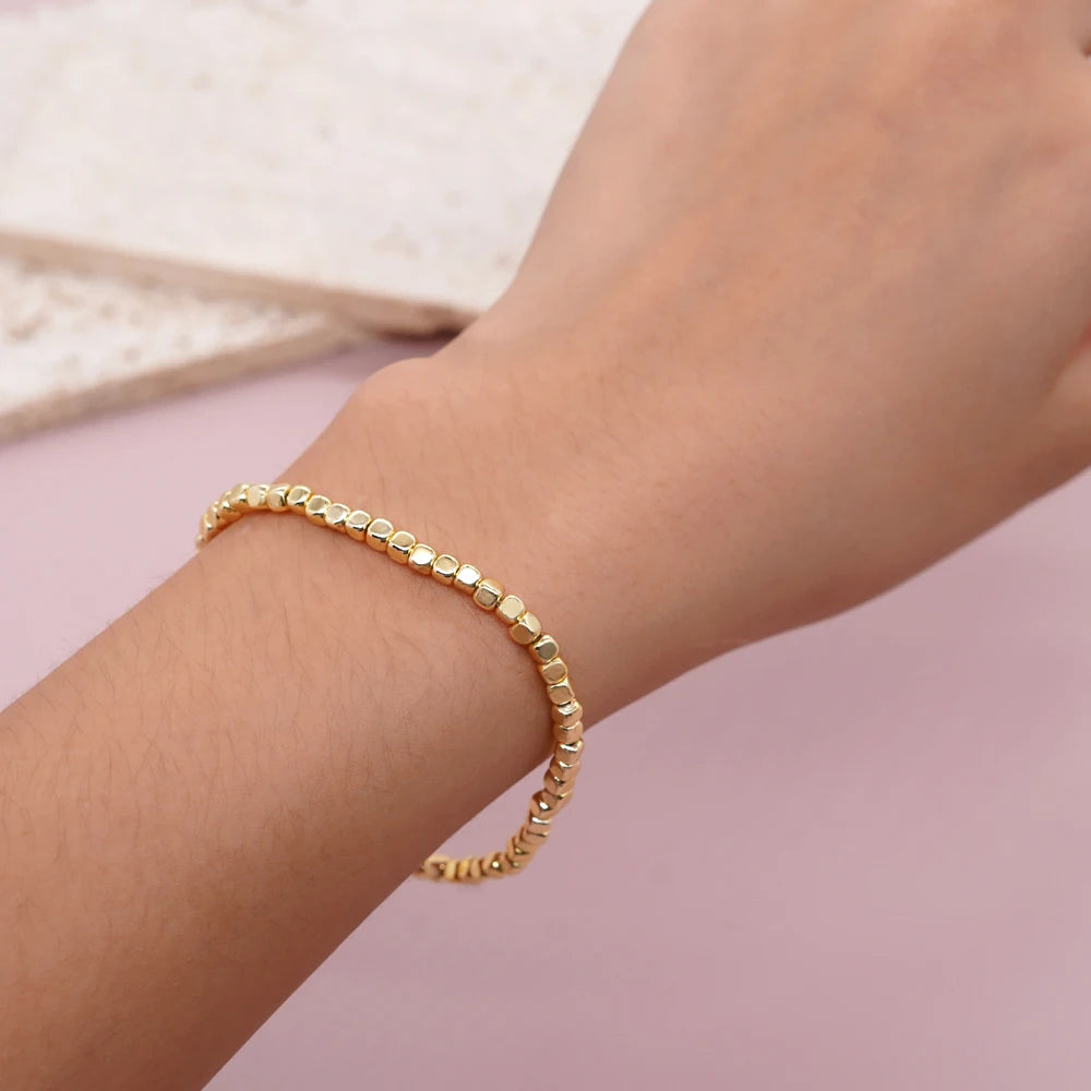 Bracelet billes dorées élastique