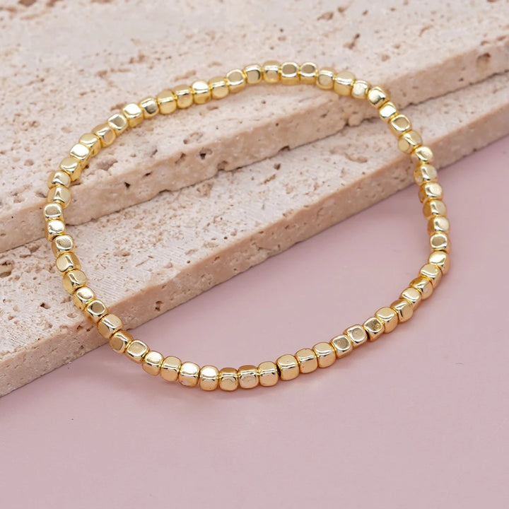 Bracelet billes dorées élastique
