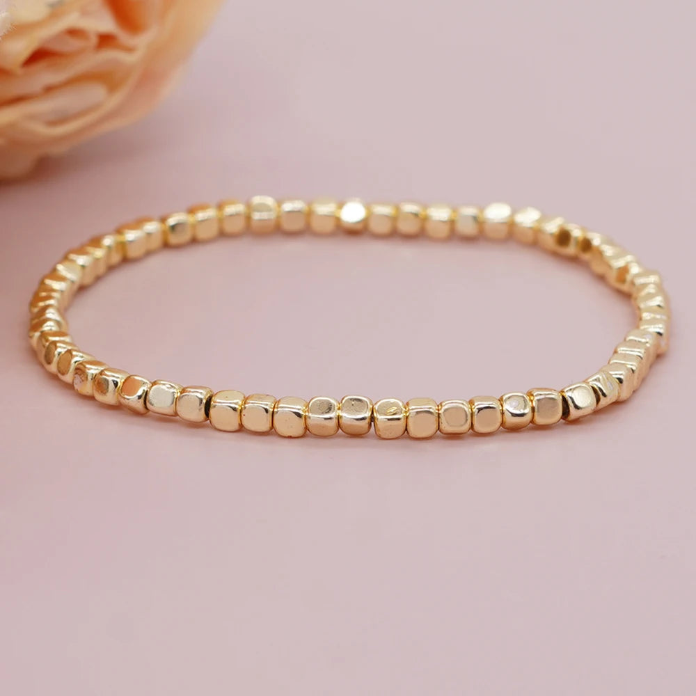 Bracelet billes dorées élastique